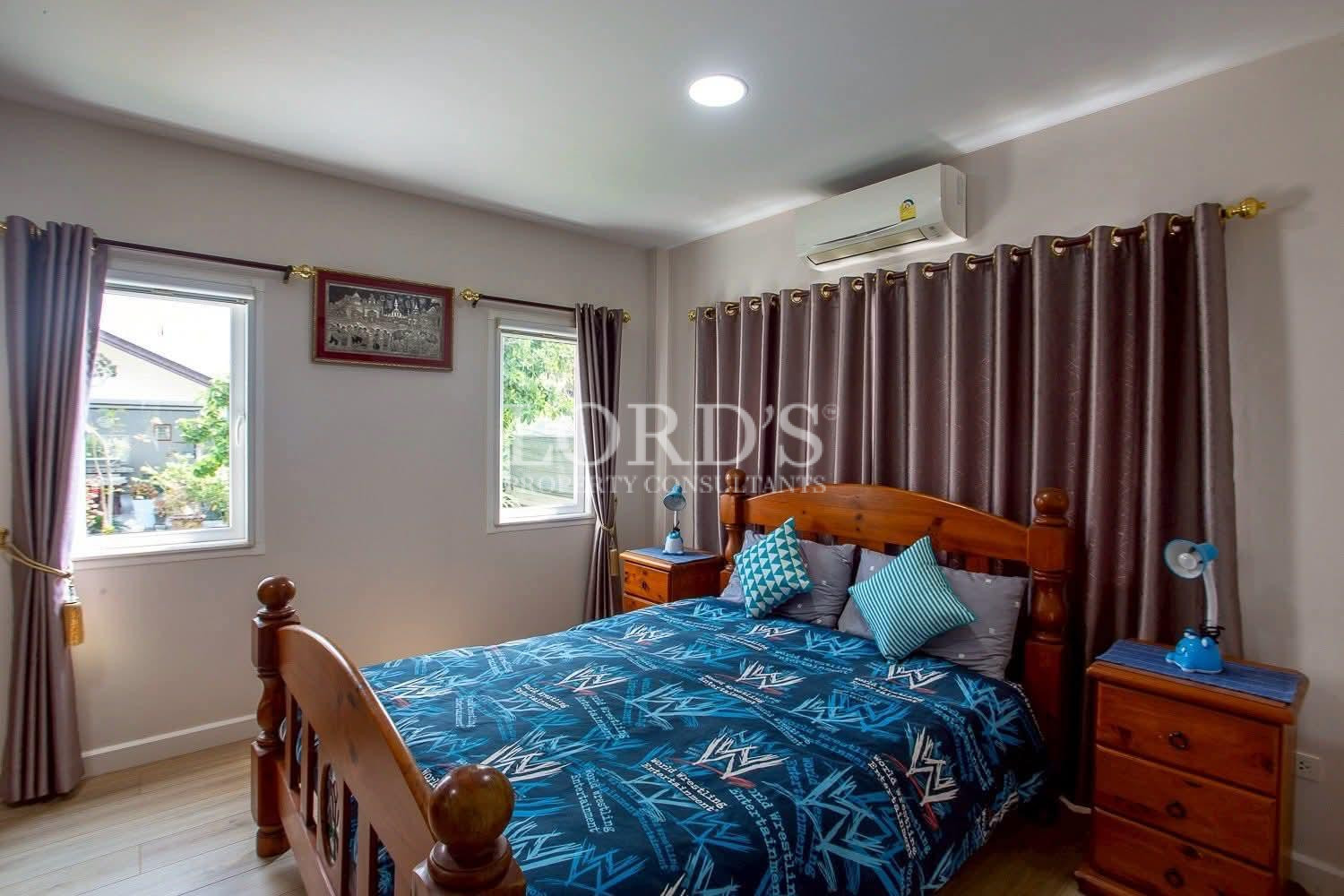 Bedroom with blue bedding and curtains
