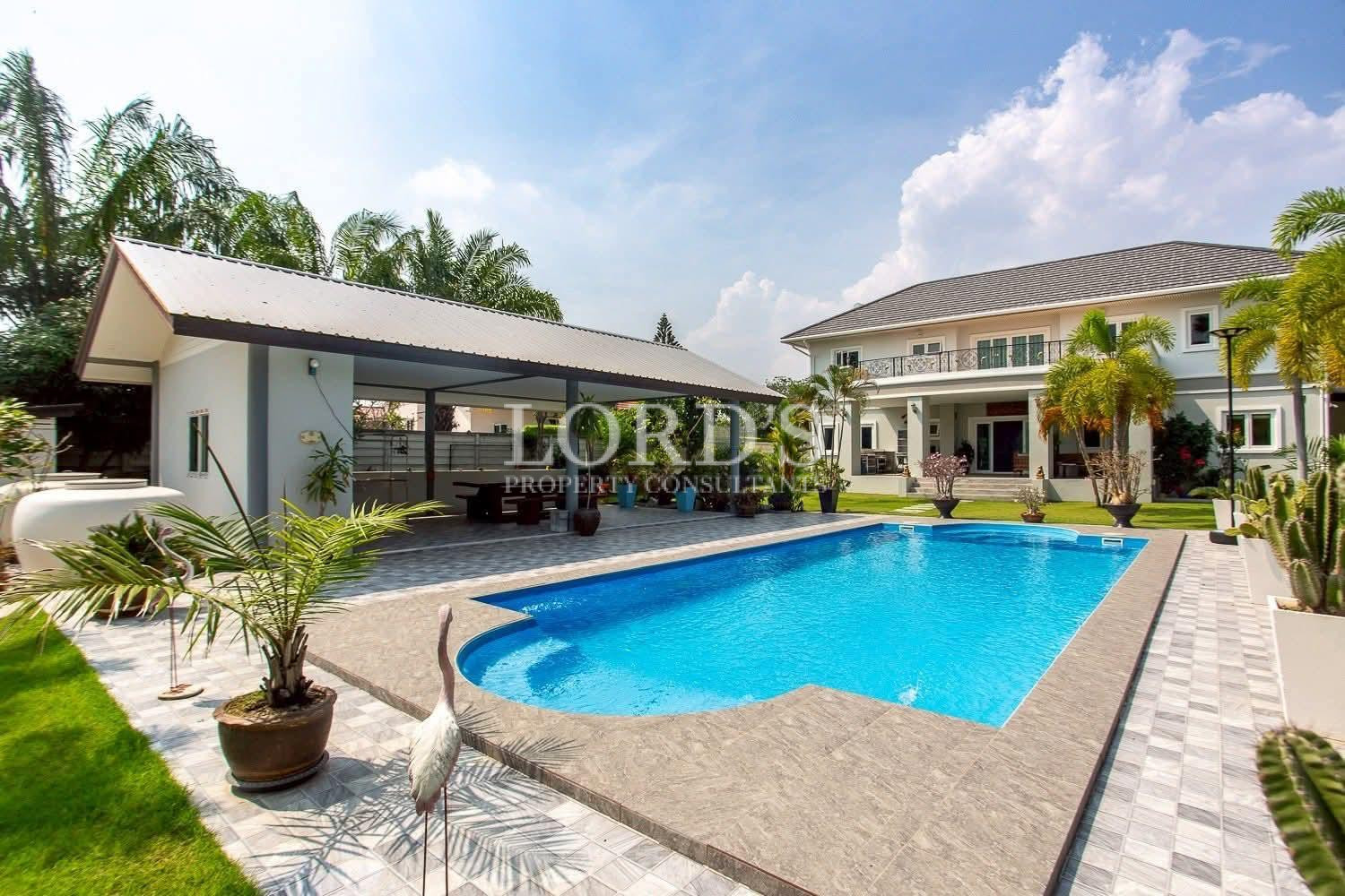 Curved swimming pool beside villa