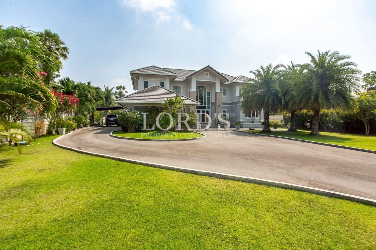 Large villa exterior with front lawn