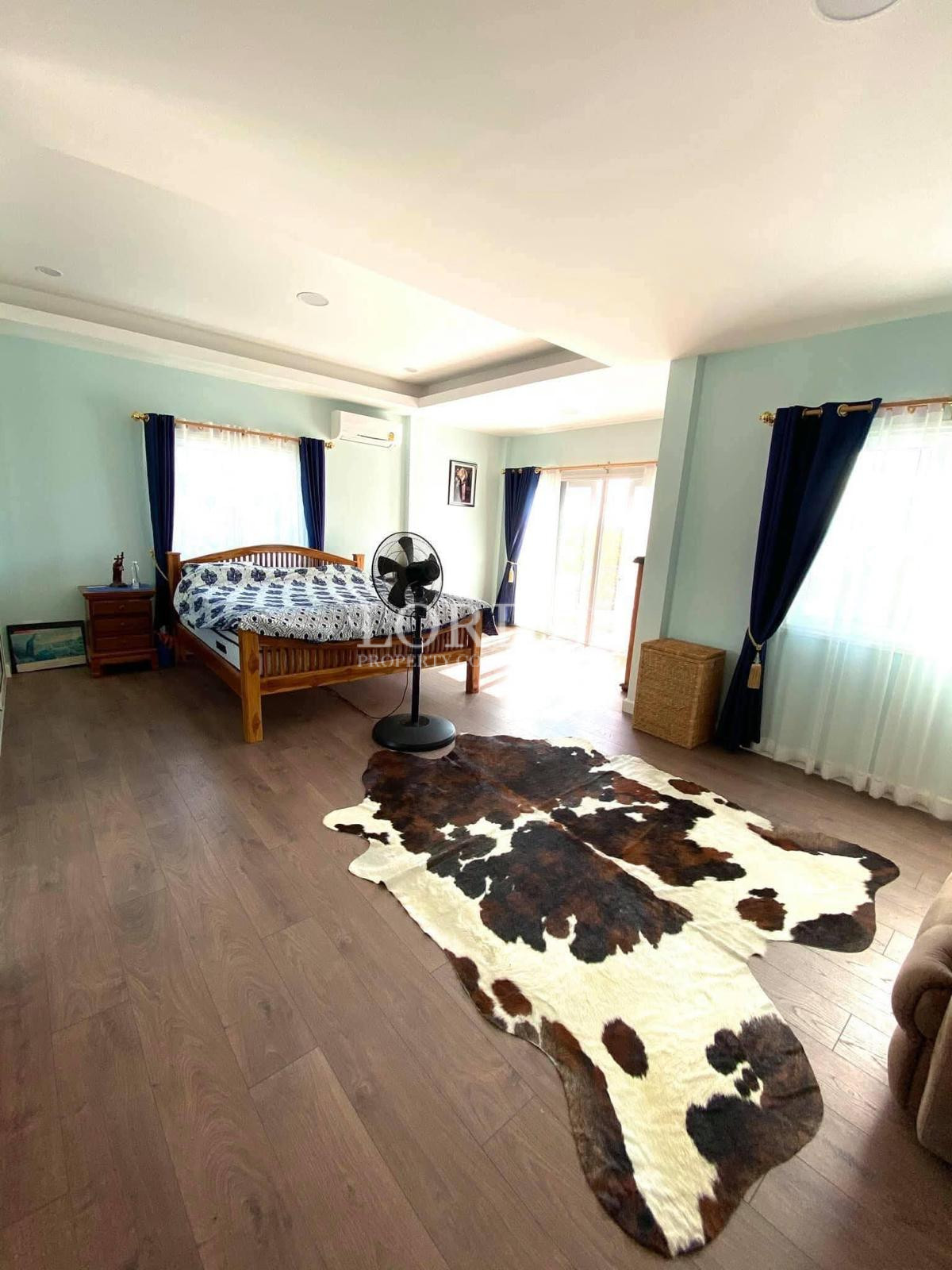 Bedroom with cowhide rug and curtains
