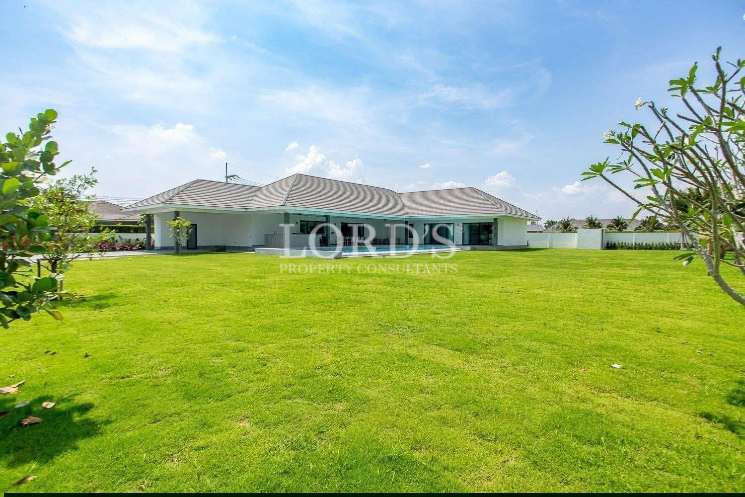 Large green lawn beside modern villa