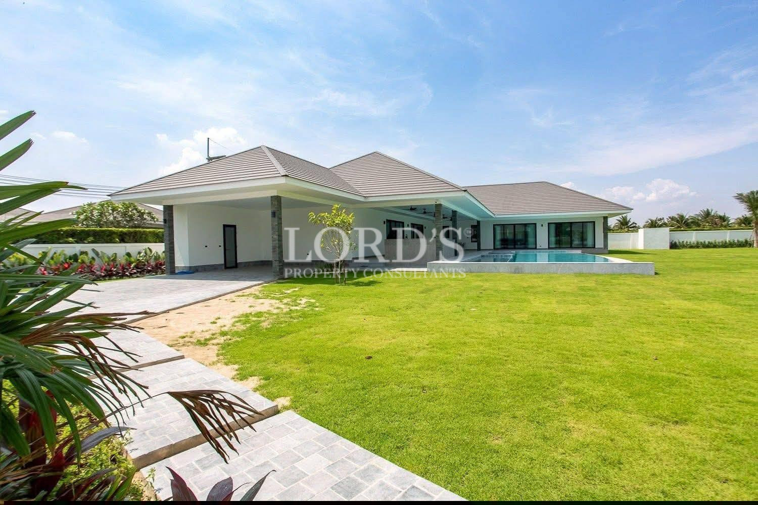 Large green lawn beside villa