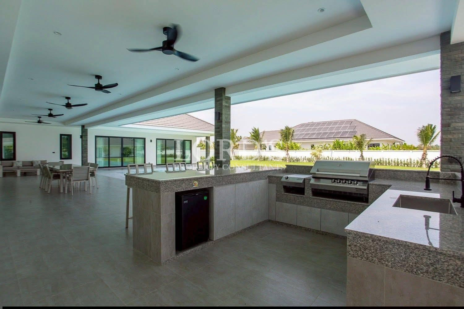 Outdoor kitchen beside pool area