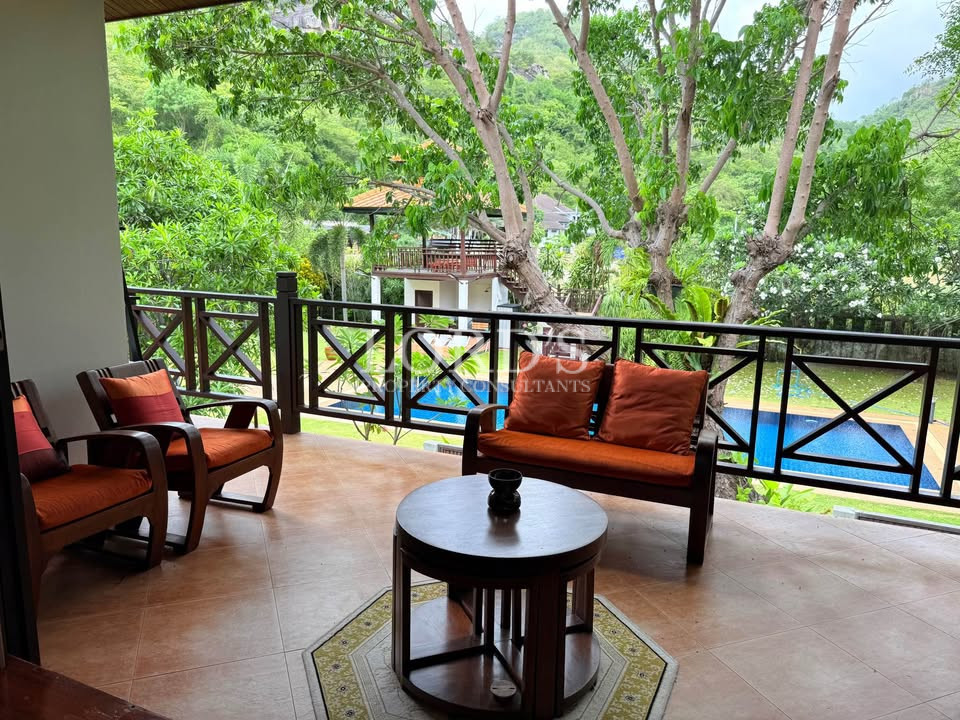 Outdoor balcony lounge with greenery