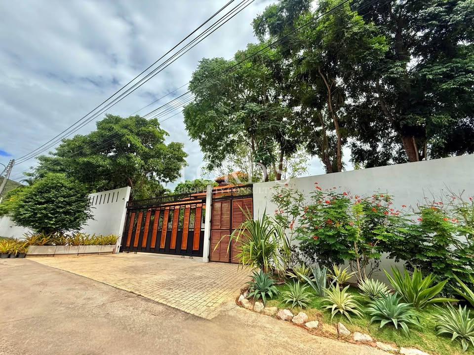 Tropical villa entrance with wooden gate