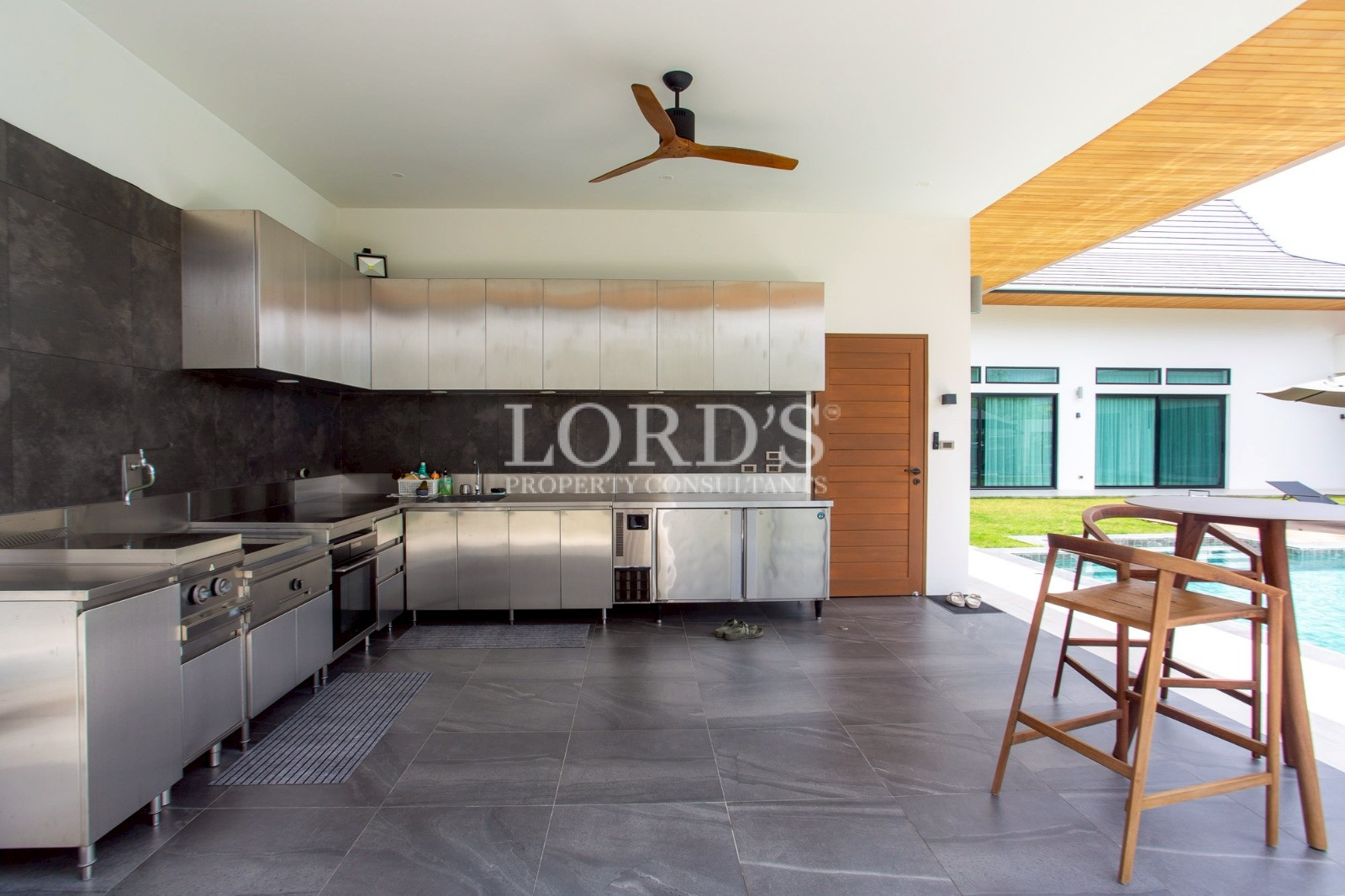 Covered outdoor kitchen with ceiling fans