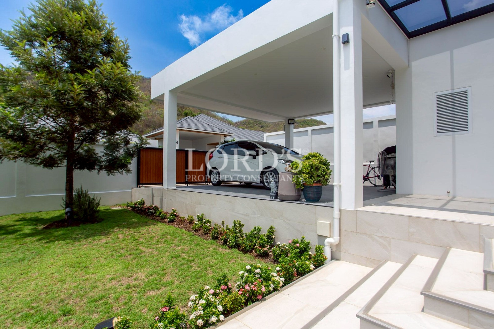 Covered carport beside modern villa