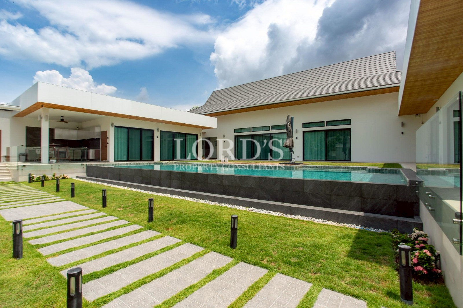 Villa with long swimming pool and lawn