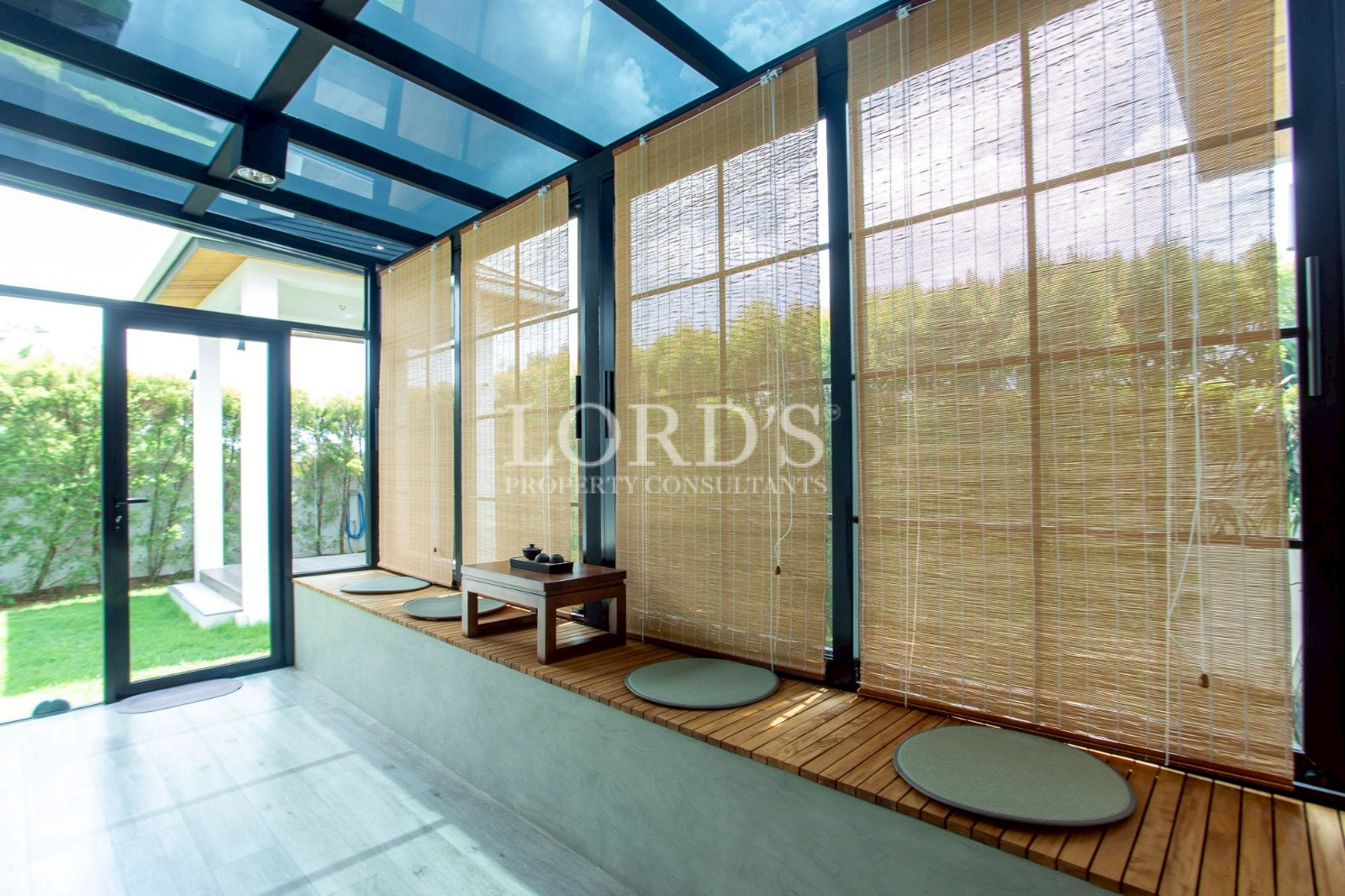 Glass-walled pavilion with lounge seating