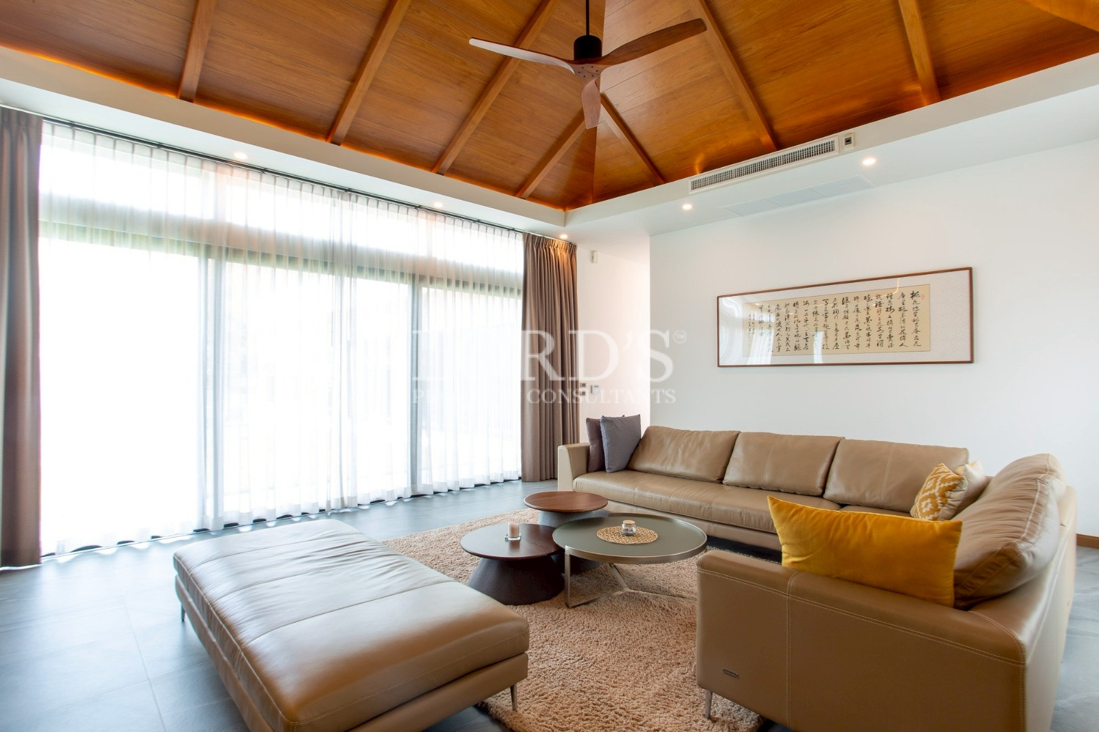 Living room with wooden ceiling and sectional sofa