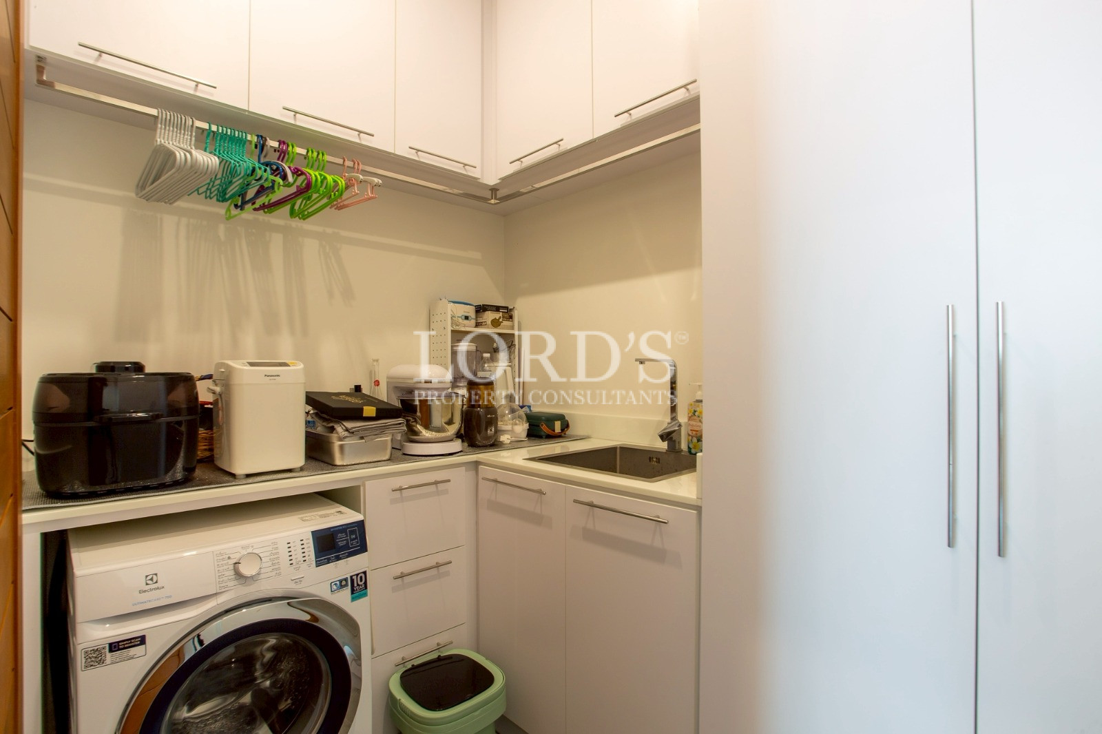Laundry room with washer and sink