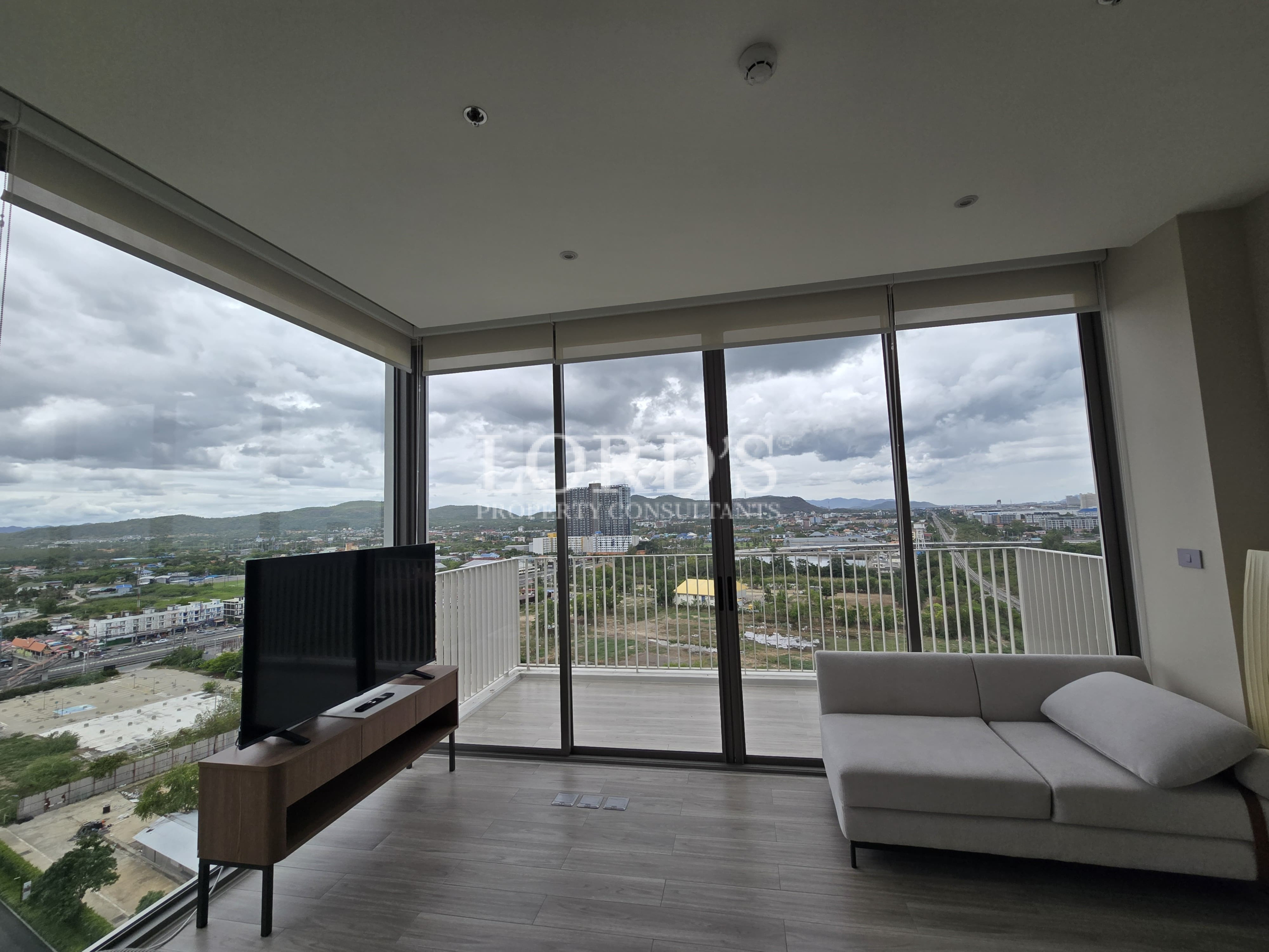 Living room with TV and panoramic city view