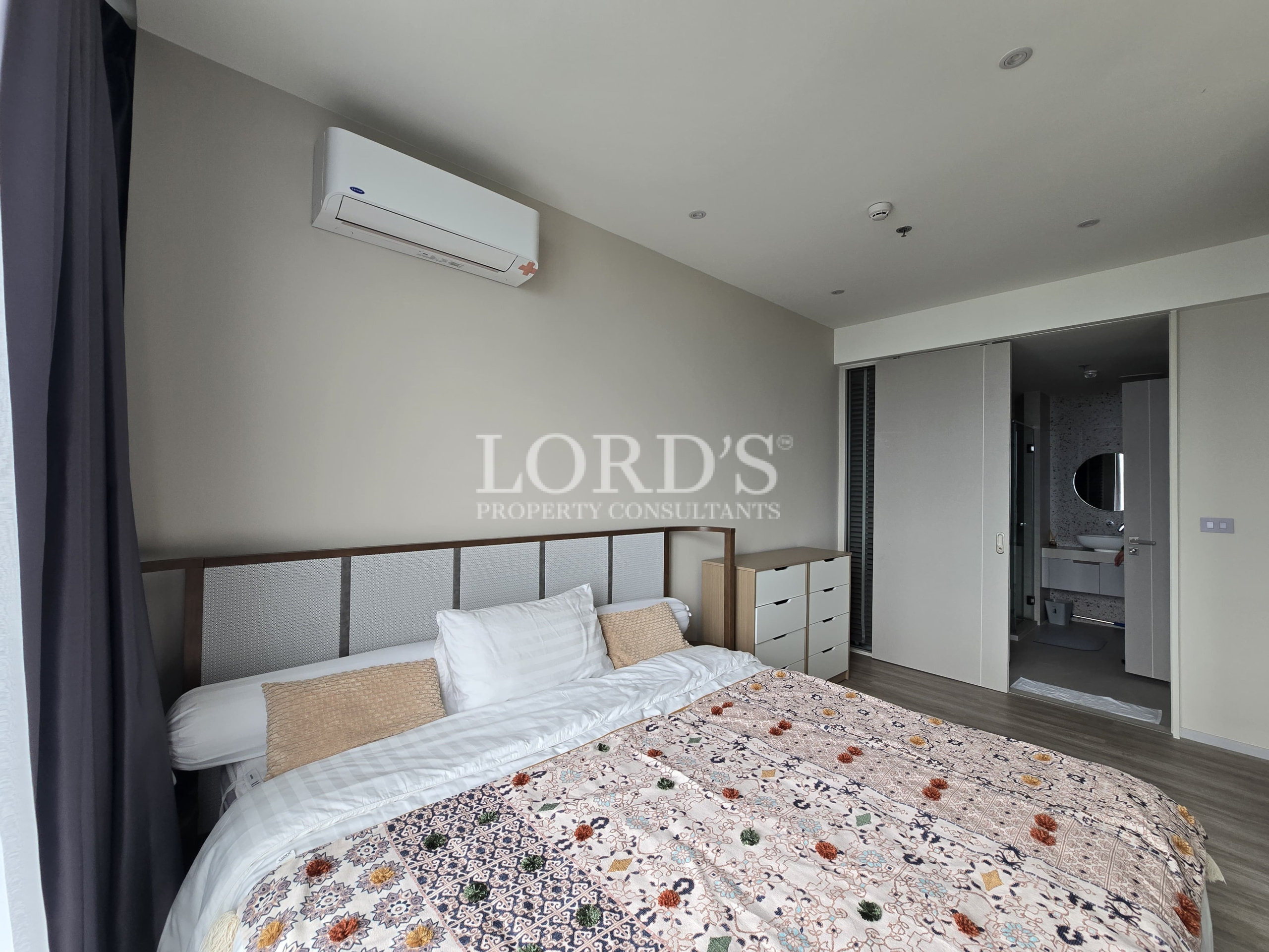 Modern bedroom with floral bedding and air conditioning