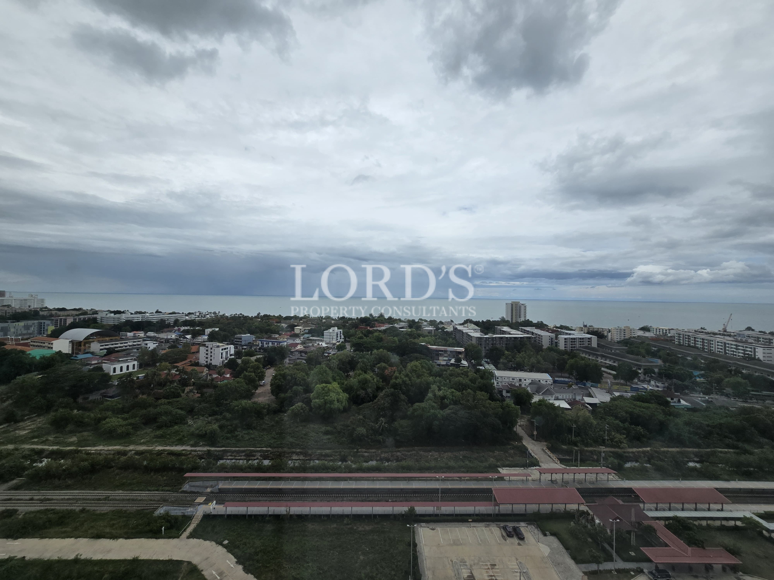 Cloudy sky over hillside residential landscape
