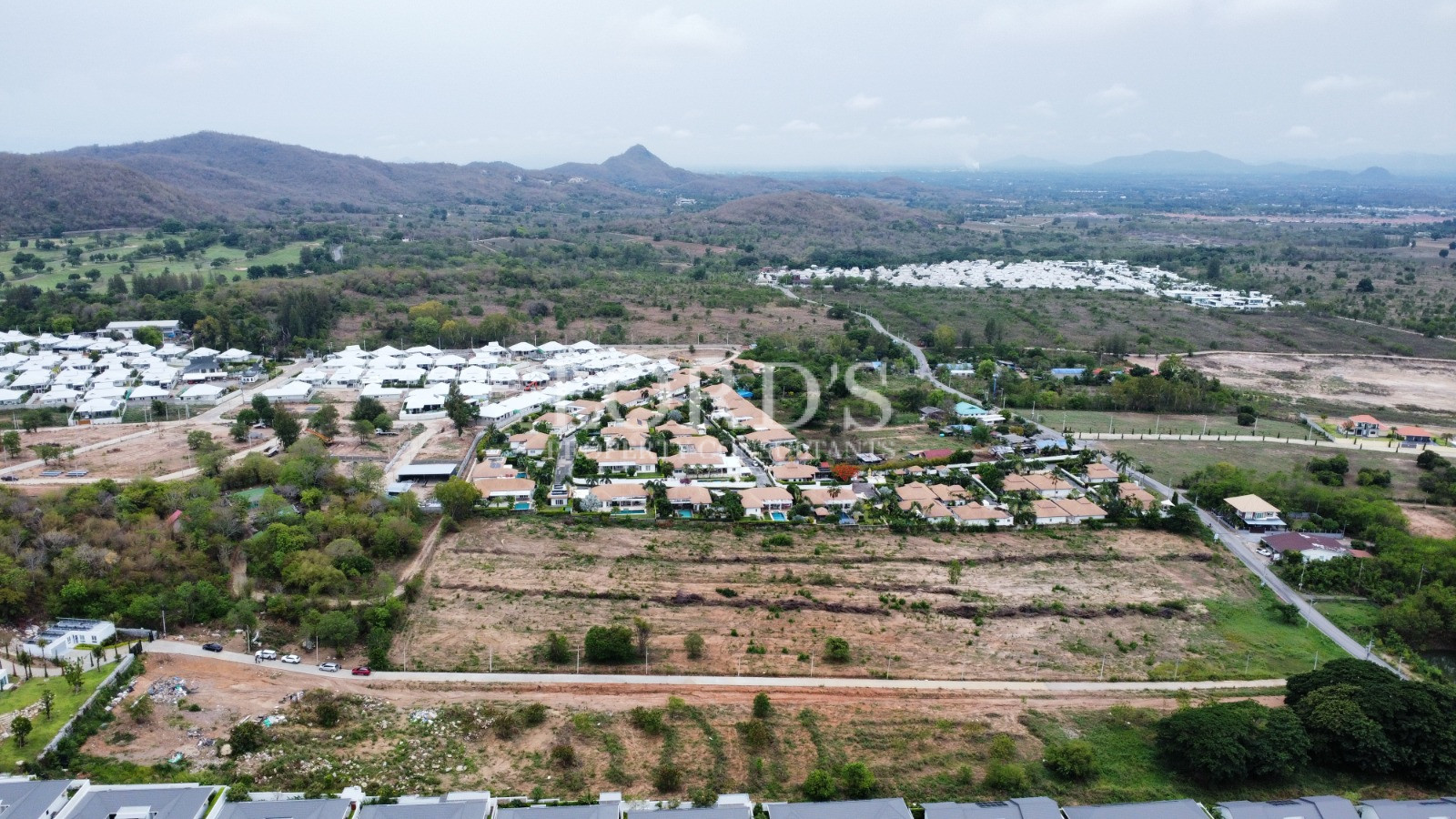 Drone view of villas surrounded by mountains