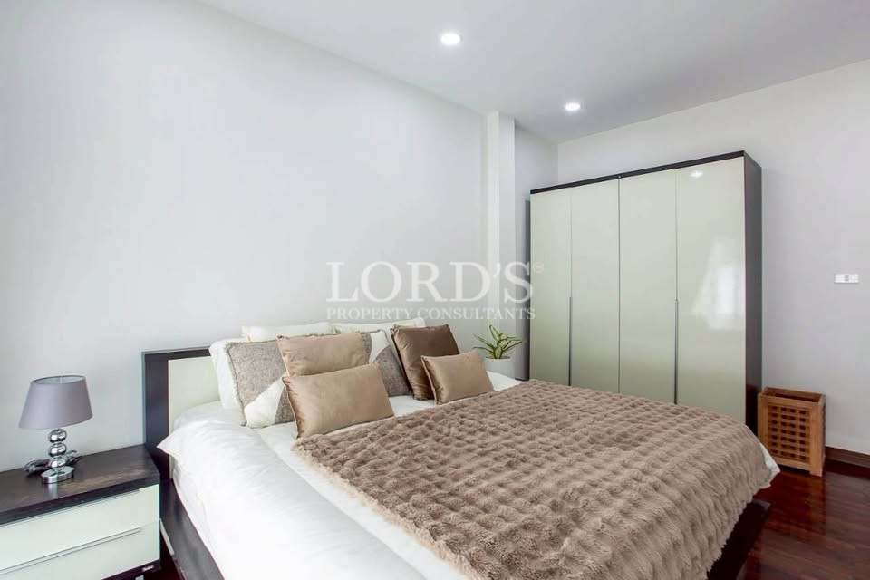 Bright bedroom with built-in wardrobe and white walls