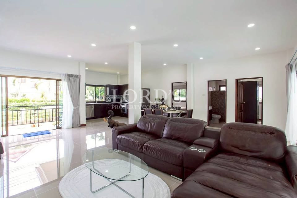 Open-plan living and dining area with large windows