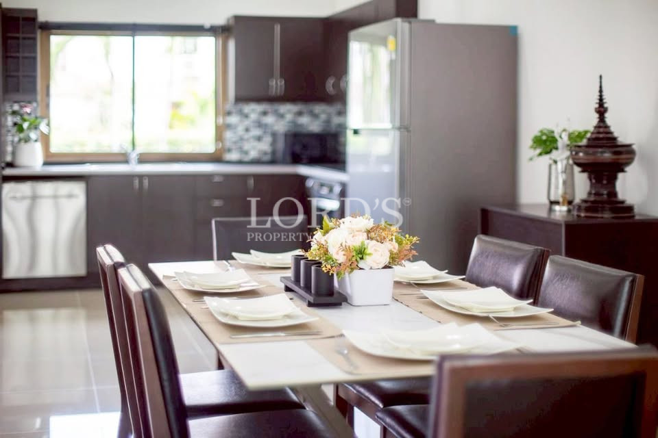 Contemporary kitchen with dark cabinetry and dining area