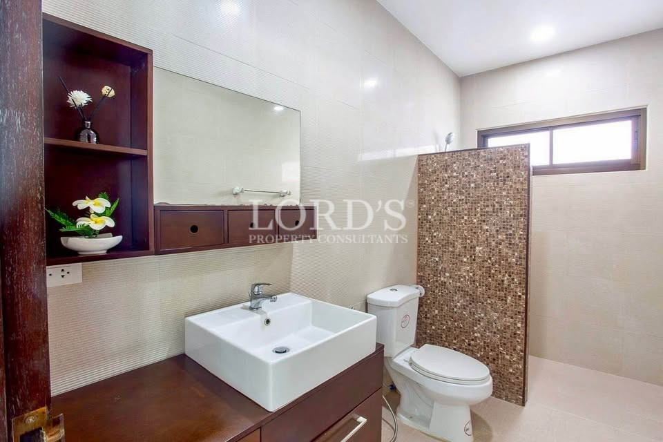 Modern bathroom with vanity and stone-textured walls