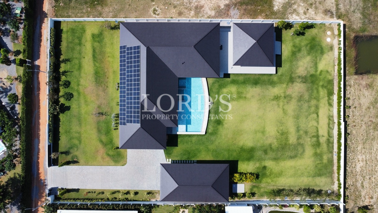 Top-down drone view of villa and landscaped grounds