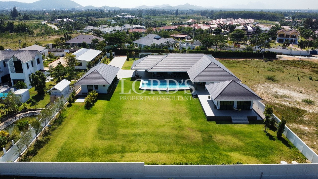 Aerial view of luxury villas and green lawns