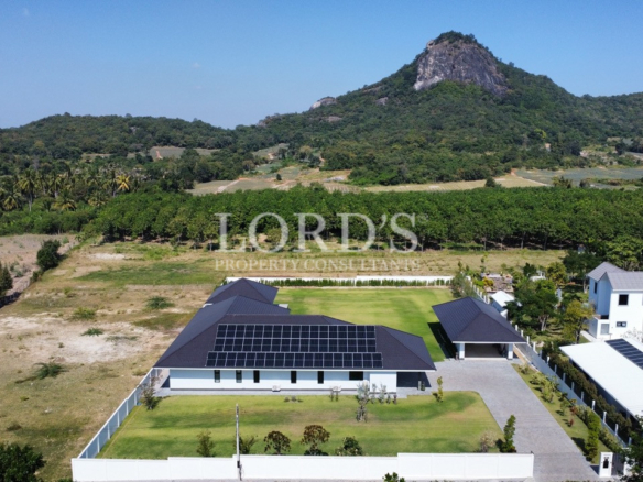Drone view of modern villa with solar panels