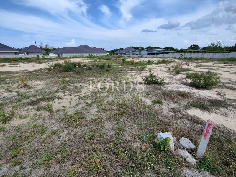 Open land plot with dry grass and cloudy sky
