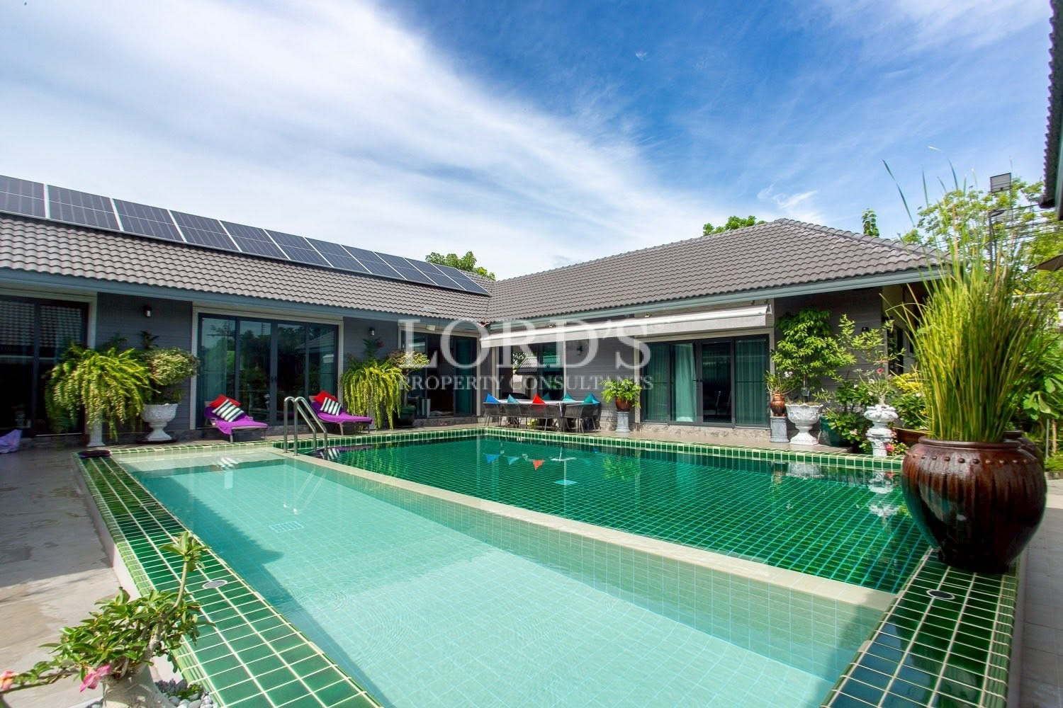 Courtyard swimming pool with villa wings