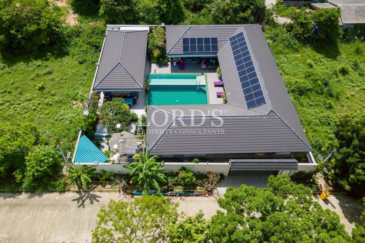 Top-down aerial view of villa and pool