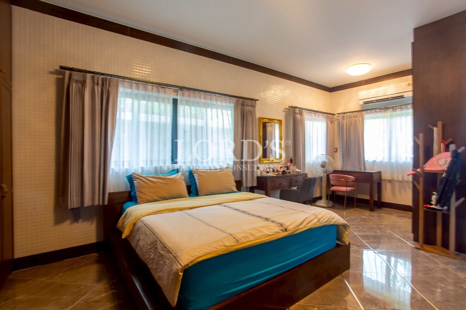 Bedroom with classic furnishings and large windows