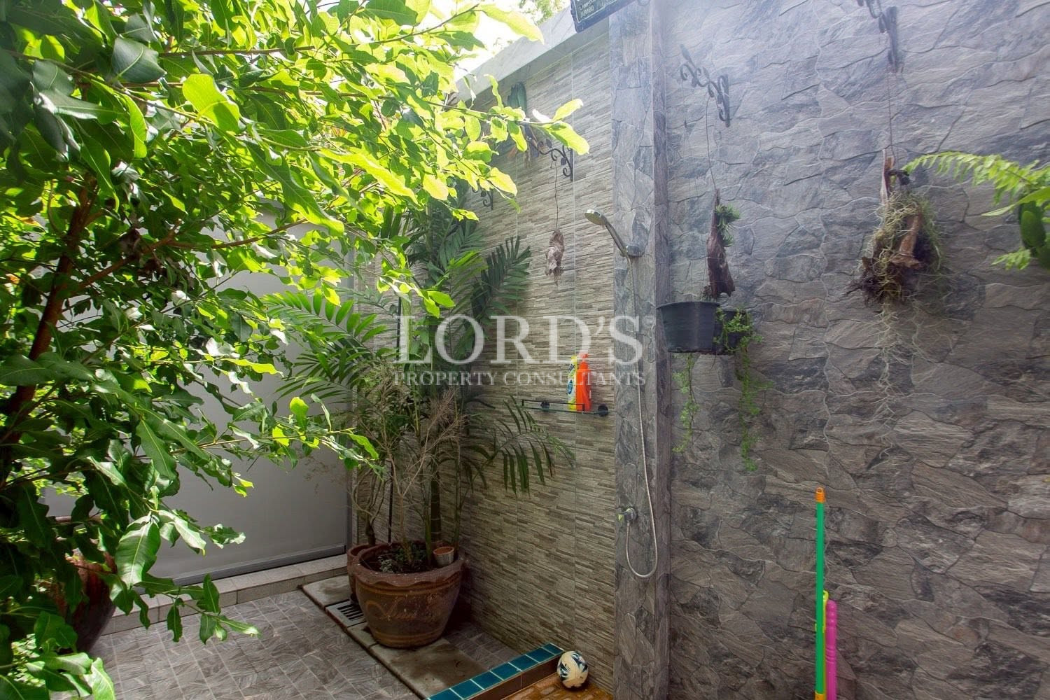 Tropical courtyard garden with stone wall