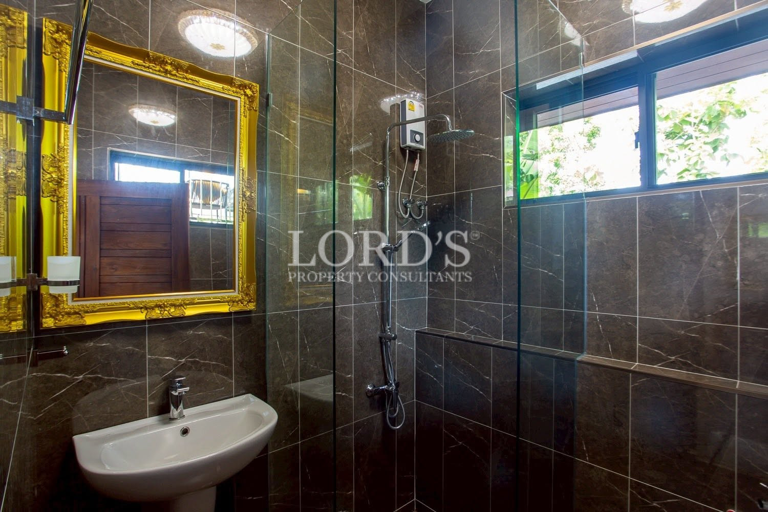 Bathroom with illuminated mirror and glass shower