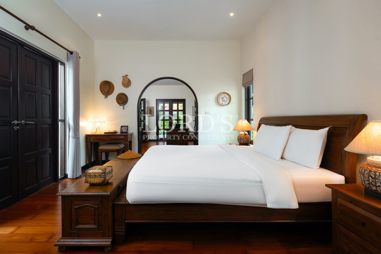 Bedroom with arched doorway and wooden accents