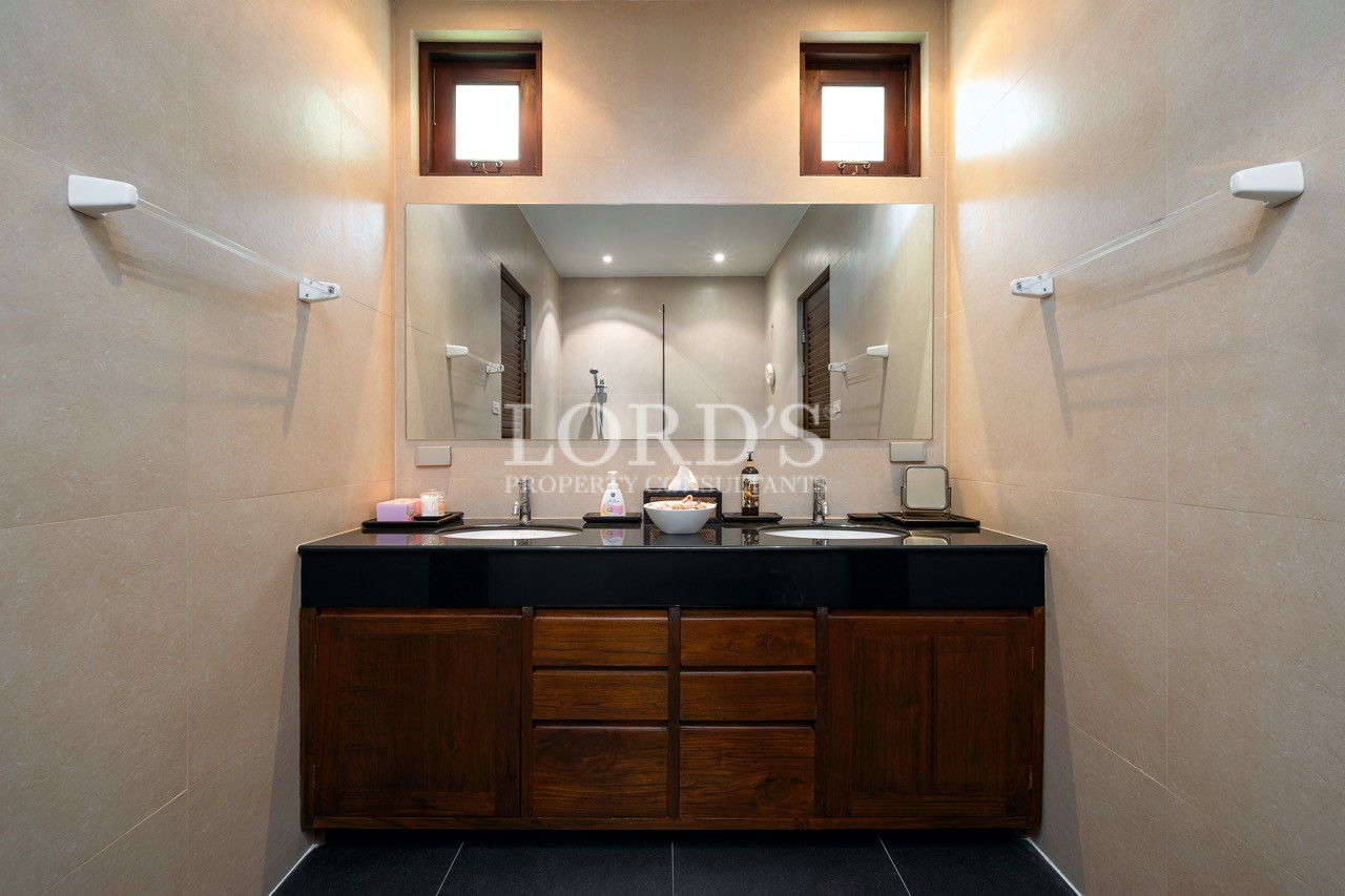 Double vanity bathroom with illuminated mirrors