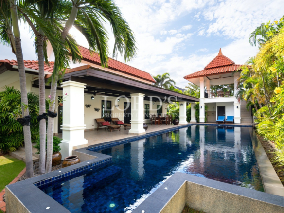Poolside villa with tropical landscaping