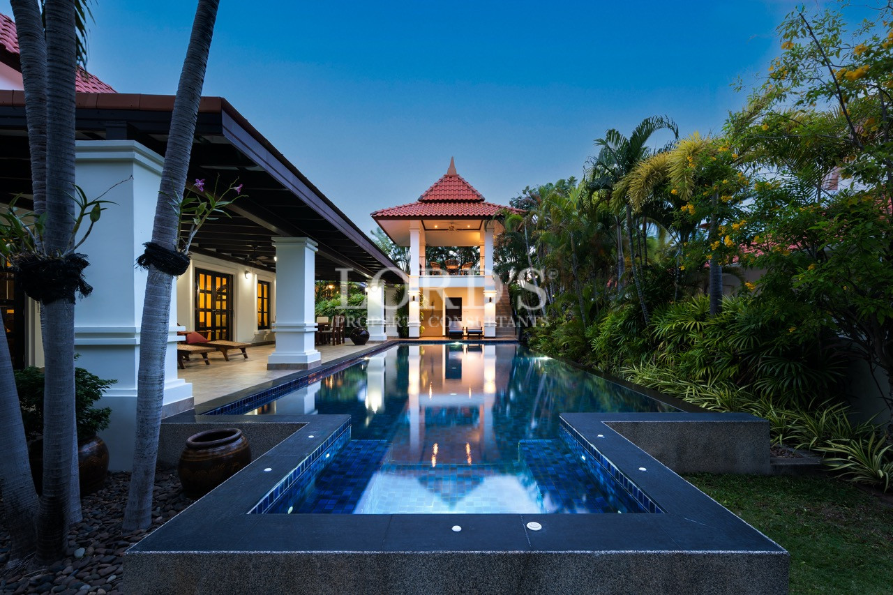 Poolside villa exterior at sunset
