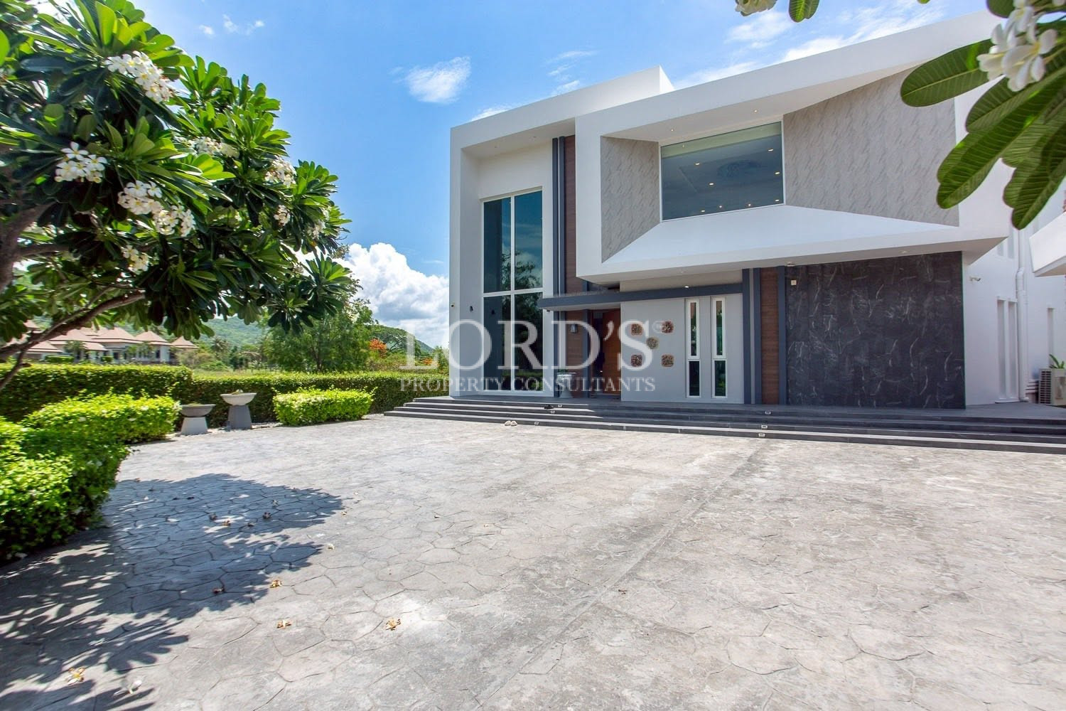 Luxury villa exterior with landscaped grounds