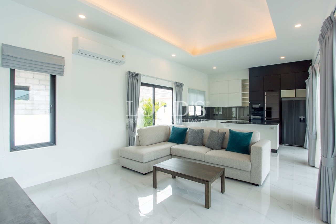 Modern bedroom with TV and kitchenette