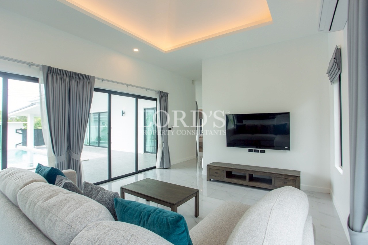 Modern bedroom with TV and balcony access