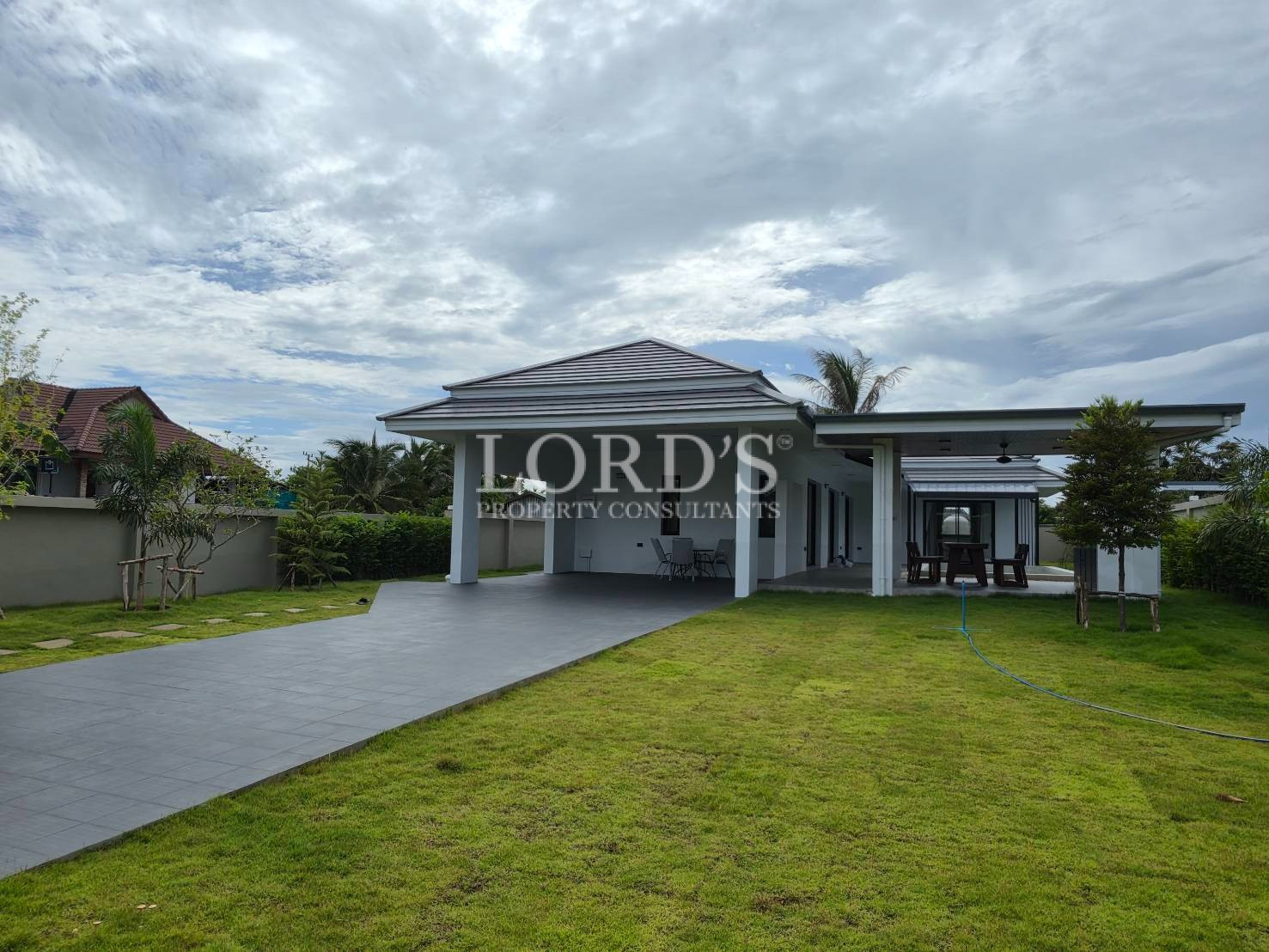 Modern villa facade with landscaped grounds