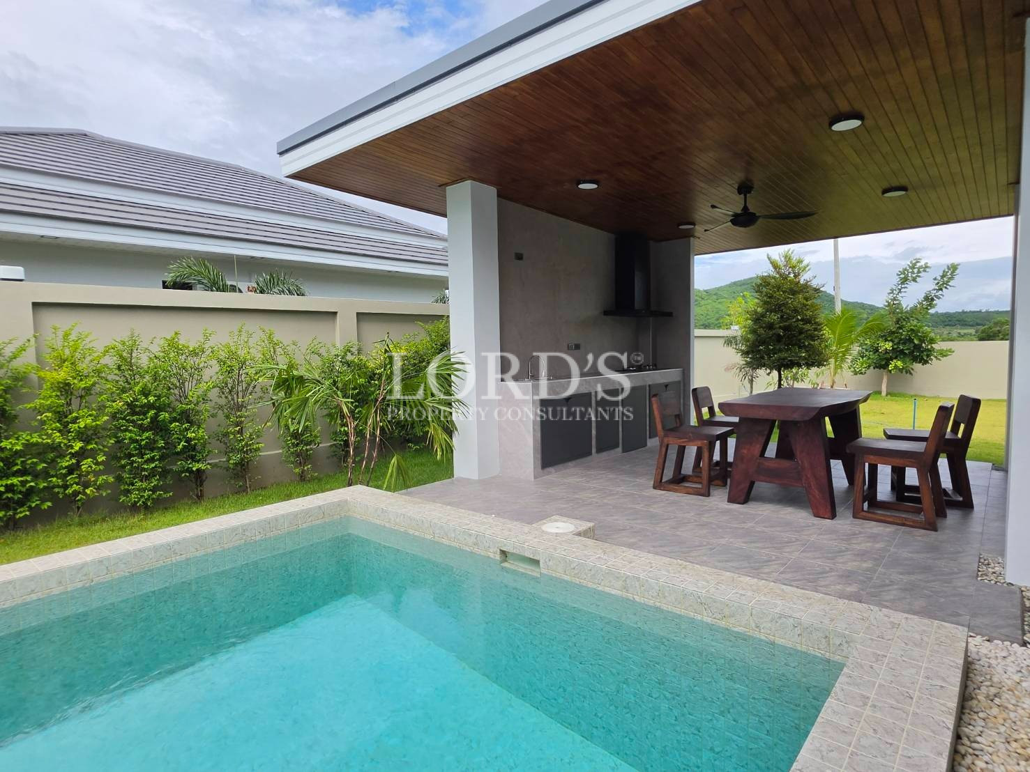 Outdoor dining terrace with wood ceiling