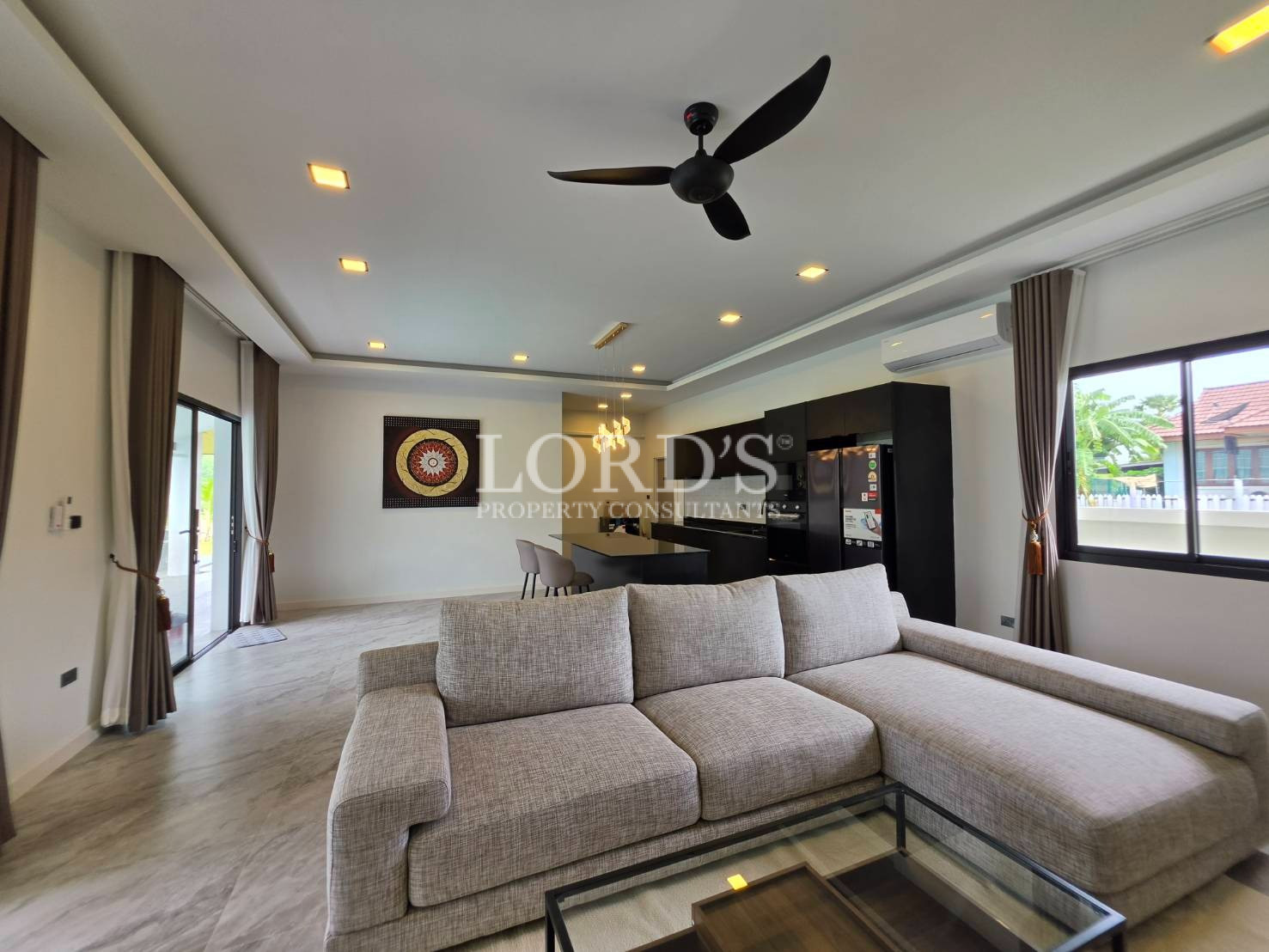 Living room with ceiling fan and open layout
