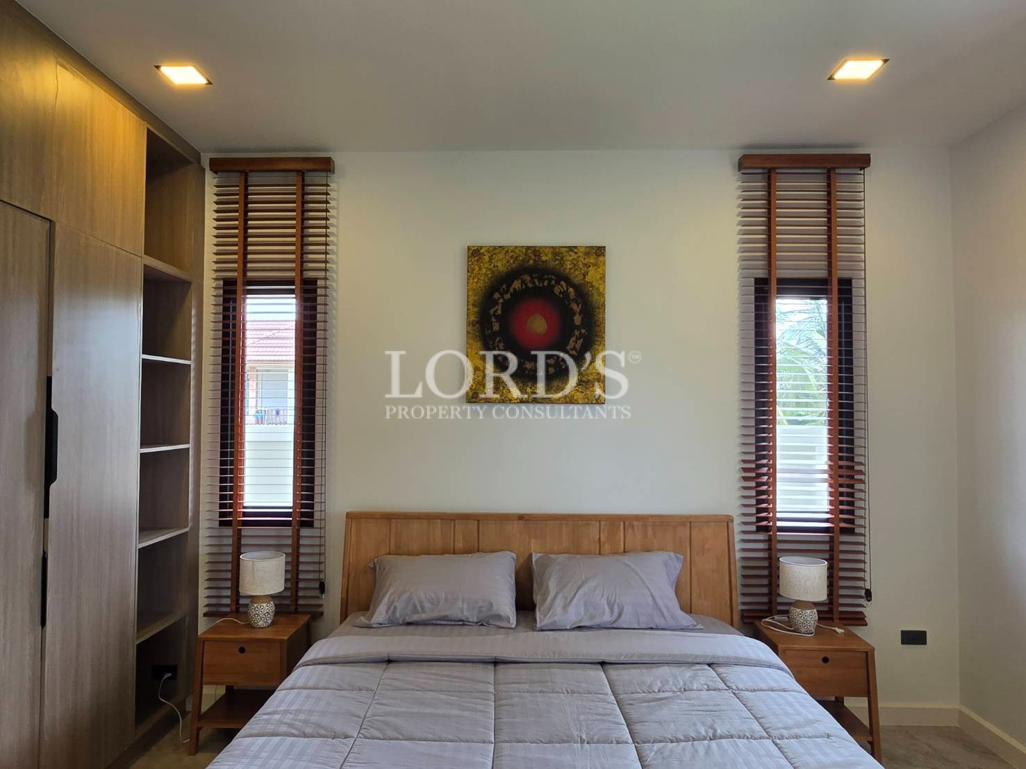 Decorative wall art between shuttered windows
