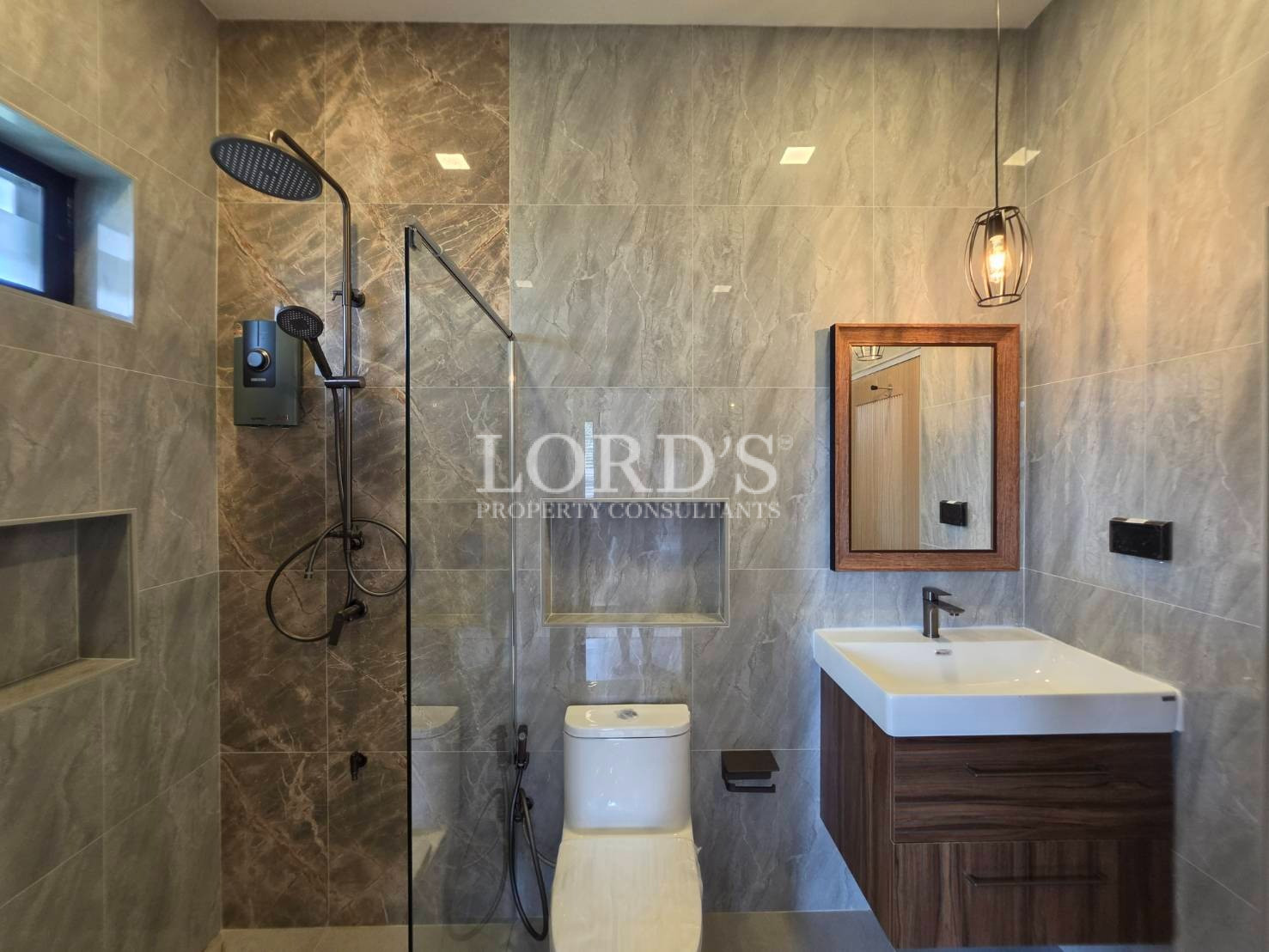 Double vanity bathroom with illuminated mirrors