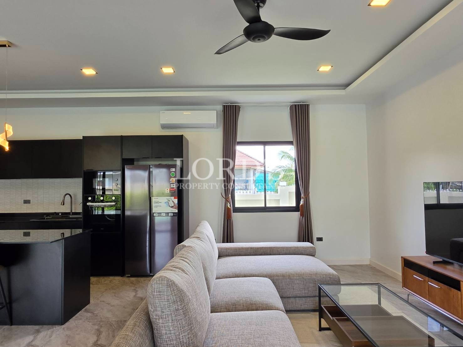 Open-plan living room with ceiling fan