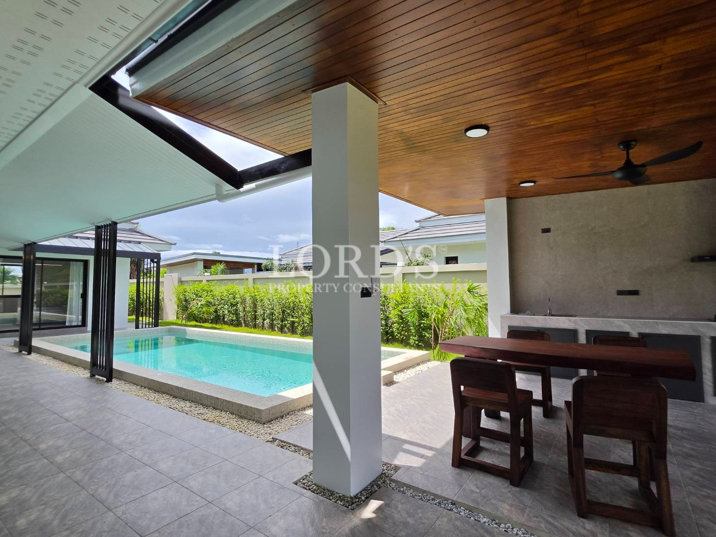 Covered outdoor terrace with wood ceiling
