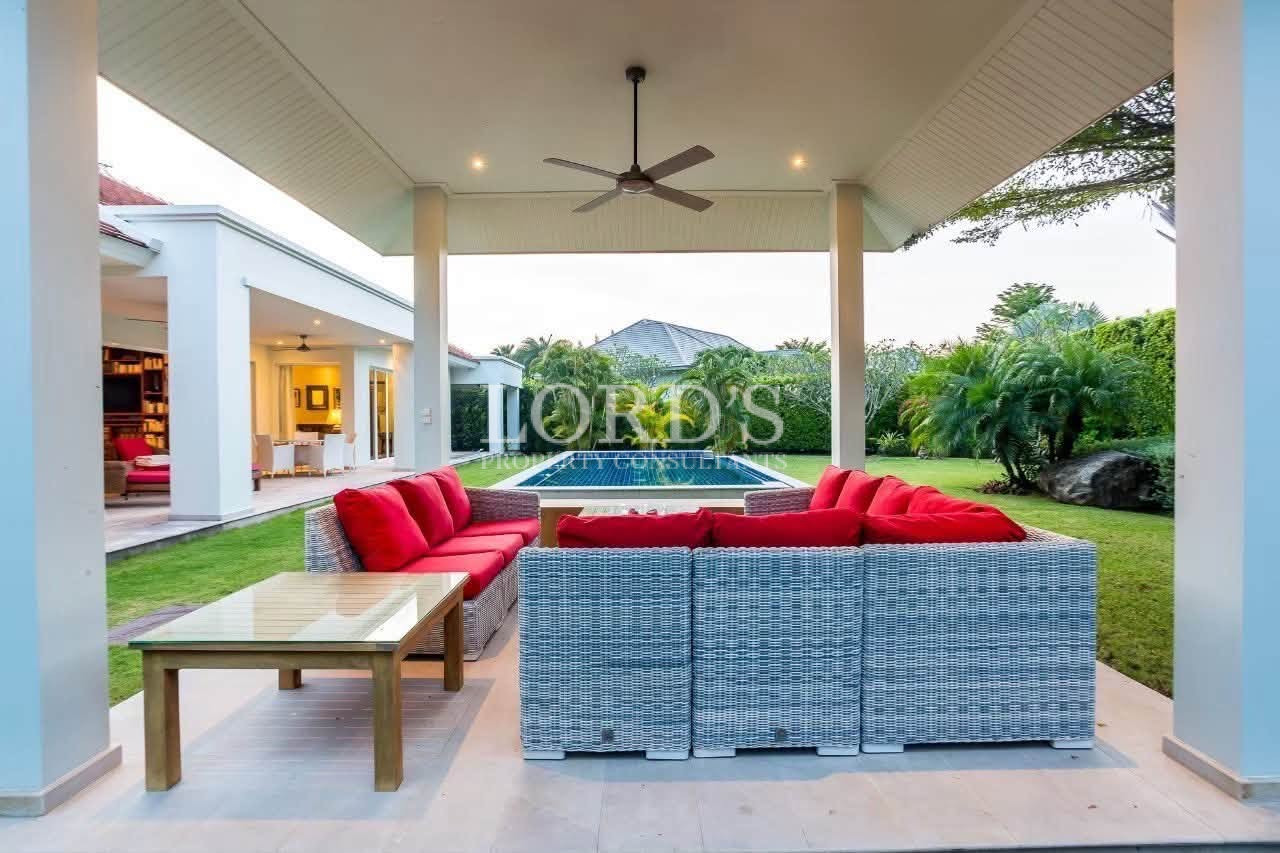 Covered outdoor lounge overlooking the pool