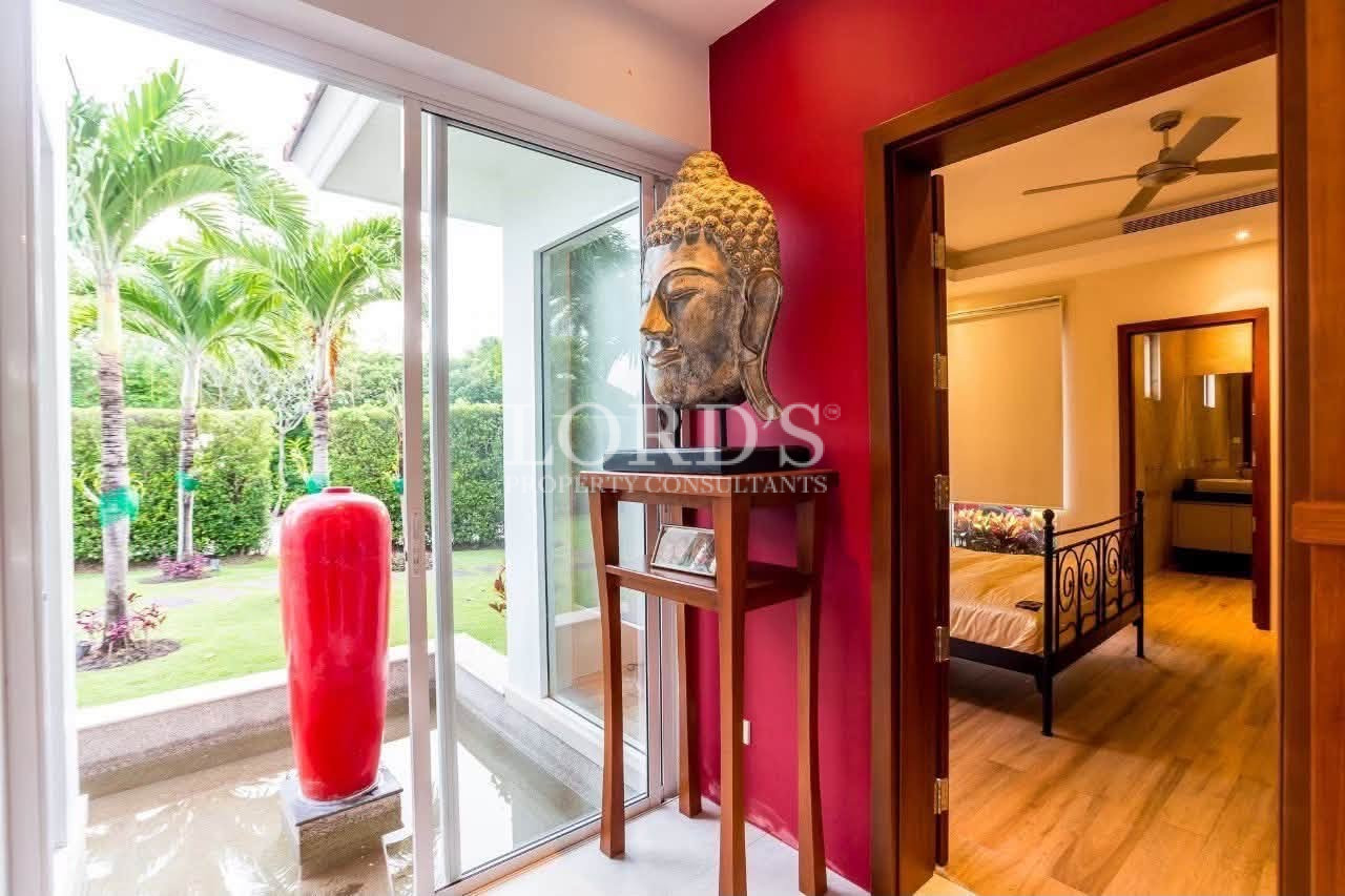 Hallway with red accent wall and artwork