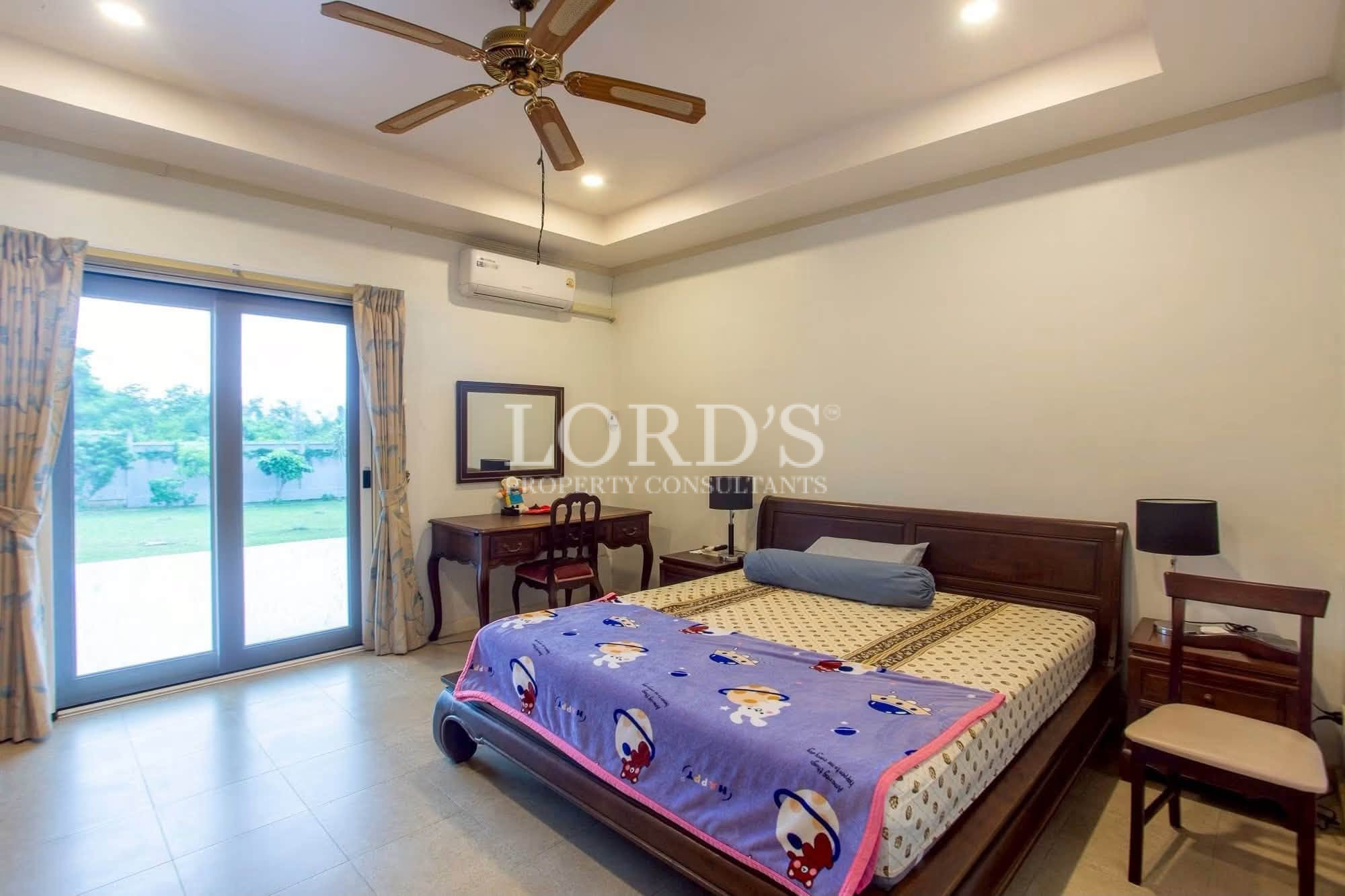 Bedroom with ceiling fan and large windows