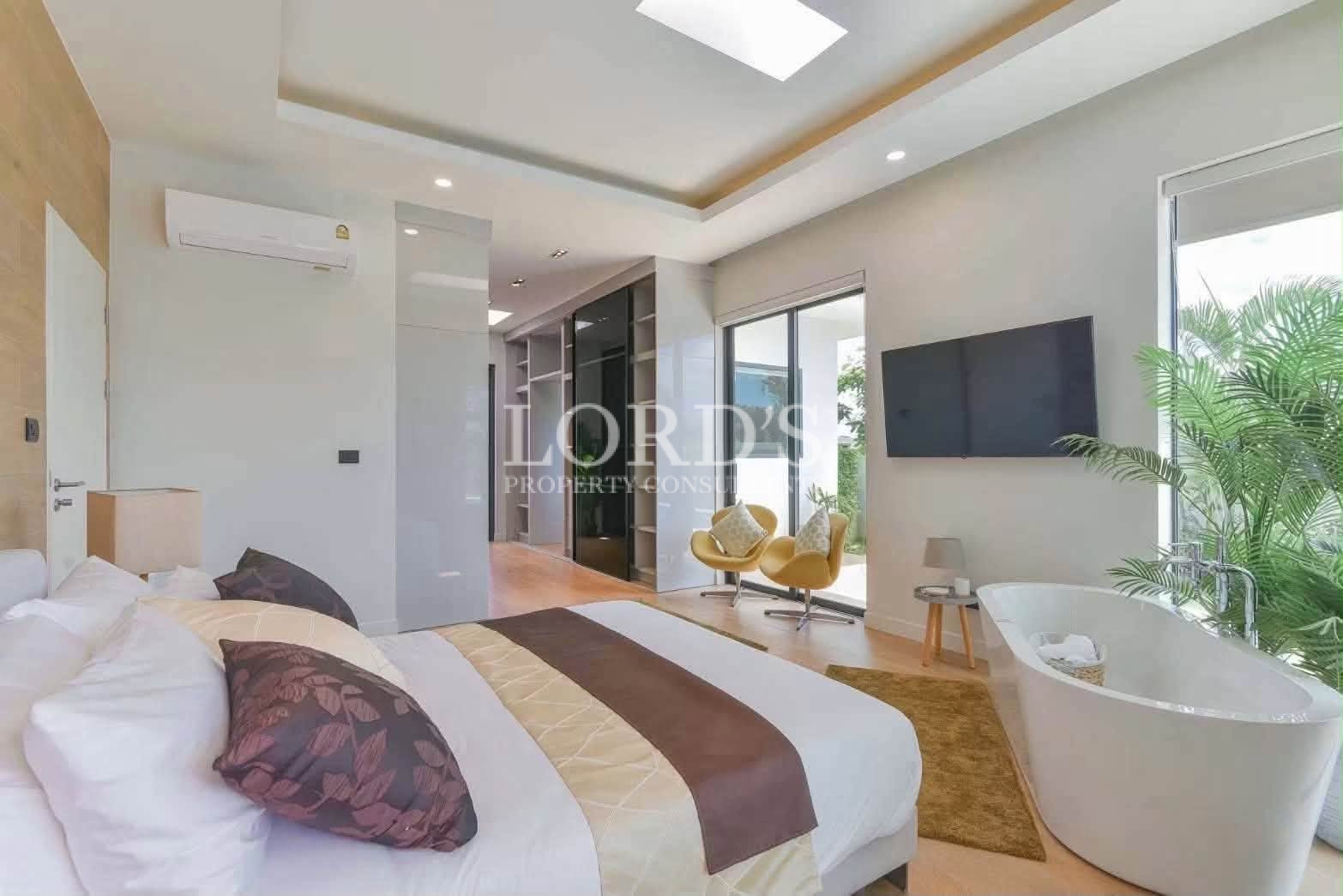 Contemporary bedroom with wall-mounted TV